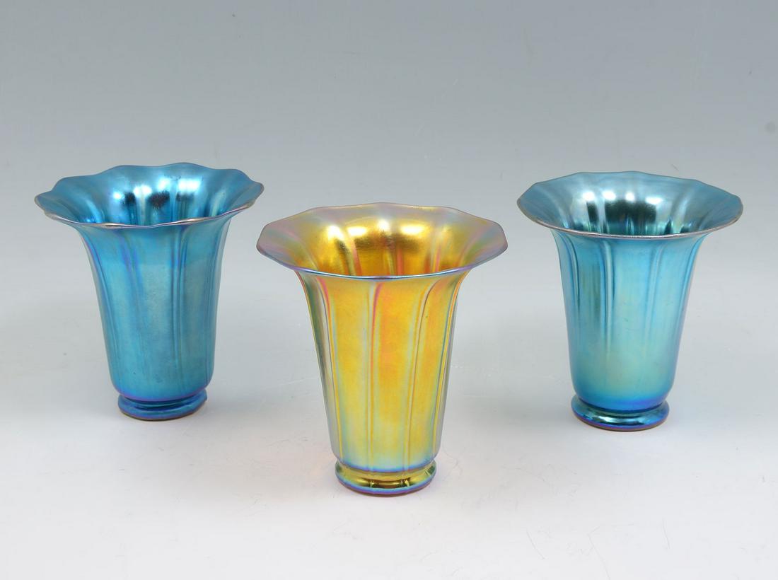 3 PC. STEUBEN ART GLASS FLORIFORM VASES: 3 PC. STEUBEN ART GLASS FLORIFORM VASES: Comprising; 2- blue aurene vases (1- signed at underside), & 1- Gold aurene vase with signature at underside. Largest Approx. 5.5'' h x 5.25'' w.