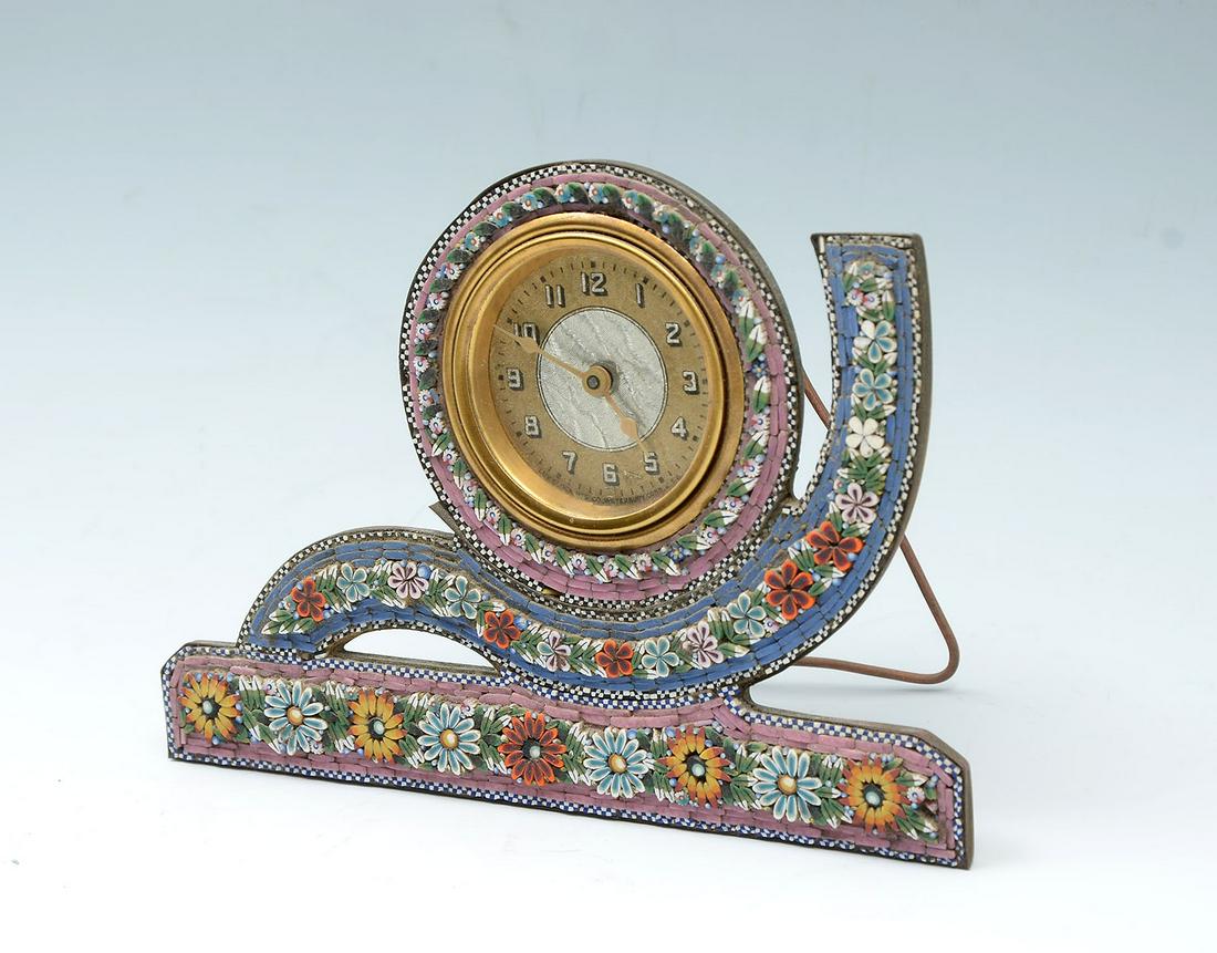 ITALIAN MICRO-MOSAIC CLOCK: ITALIAN MICRO-MOSAIC CLOCK: Italian micro mosaic frame, having a floral design with checkered borders. Lux Clock Mfg. Co., Waterbury, Connecticut. Attached copper stand. Approx. 4.75'' h x 6.75'' l x 