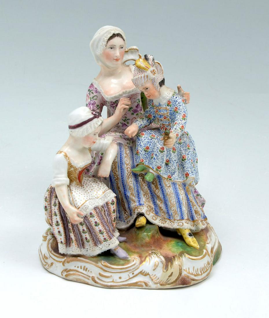 MEISSEN PORCELAIN FIGURAL GROUPING: MEISSEN PORCELAIN FIGURAL GROUPING: Elaborately painted Meissen porcelain in the form of a female sitting with a child on lap & at side. All on a scrolling base. Crossed swords mark at underside. Appr