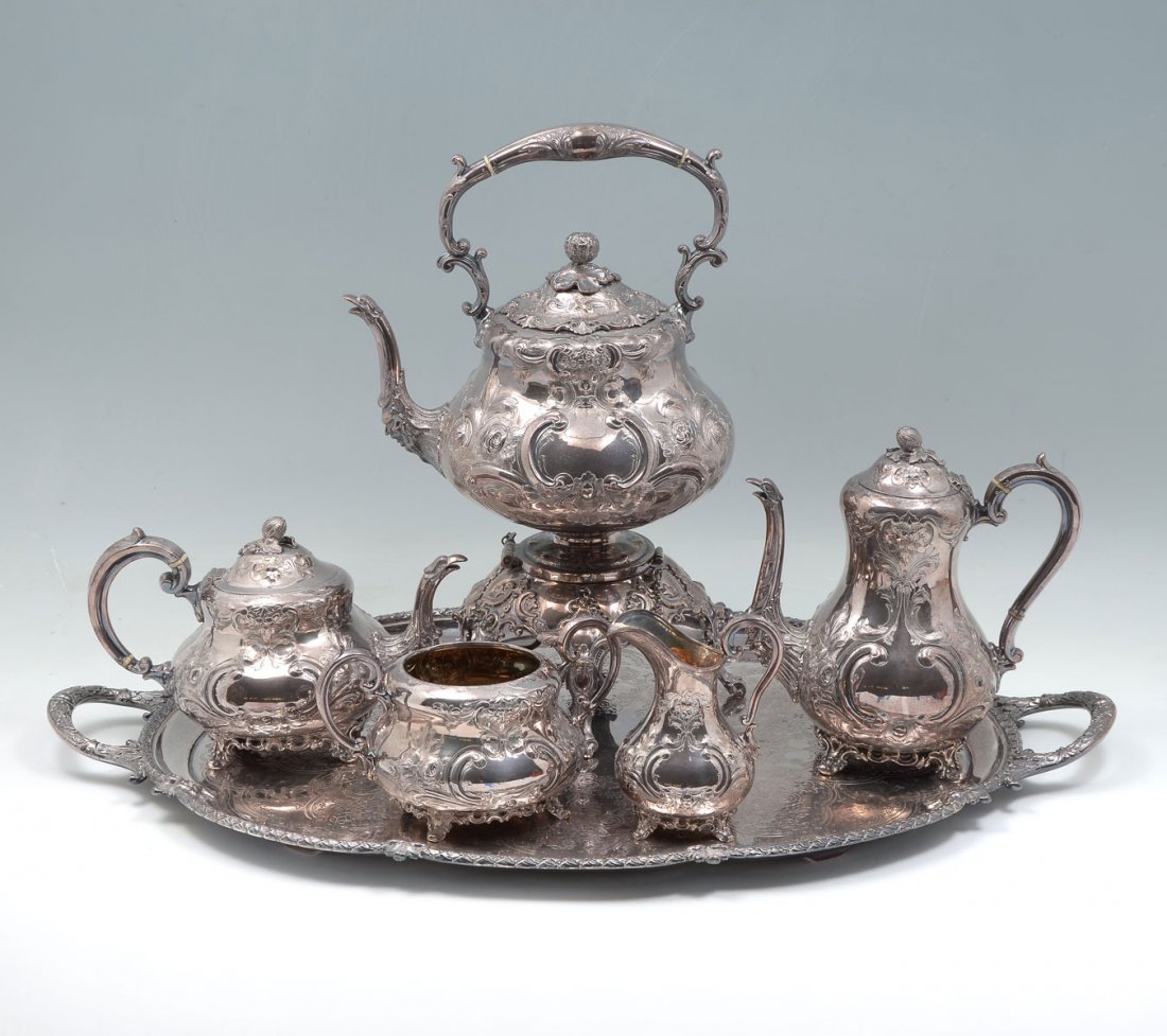 MARTIN HALL & CO TEA AND COFFEE SERVICE: ORNATE MARTIN HALL & CO SILVER PLATED TEA AND COFFEE SERVICE: Comprising; 1- Water pot with sterno, 1- Coffee pot, 1- Tea pot, 1- Sugar bowl with no lid, 1- Creamer, & 1- Butler's serving tray. Larges