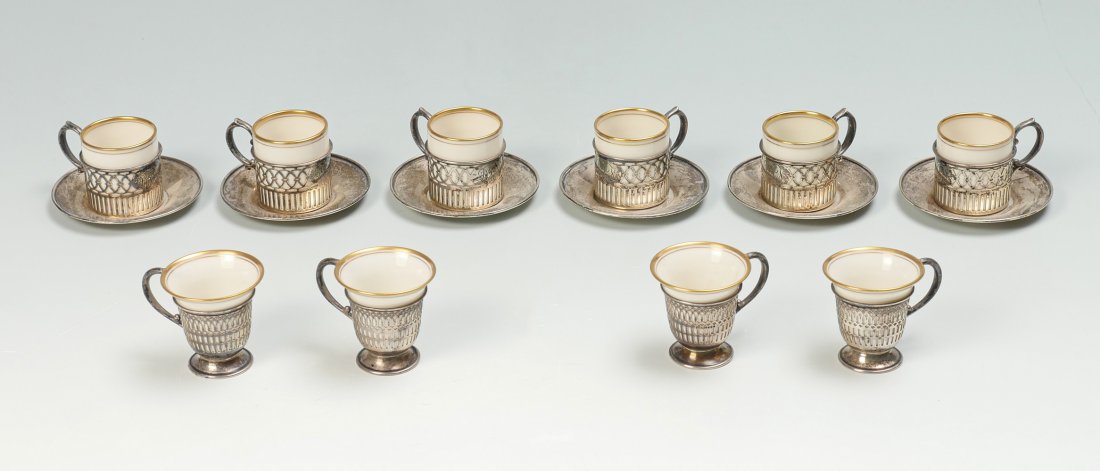 12 PC. LENNOX DEMITASSE CUPS & SAUCERS IN STERLING: 12 PC. LENNOX DEMITASSE CUPS & SAUCERS IN STERLING: Approx. 11.00 Troy ounces. Comprising; 6- cylindrical Lenox porcelain cups in a Sterling handled holder cups, by Watson Co., monogrammed. 6- Sterlin