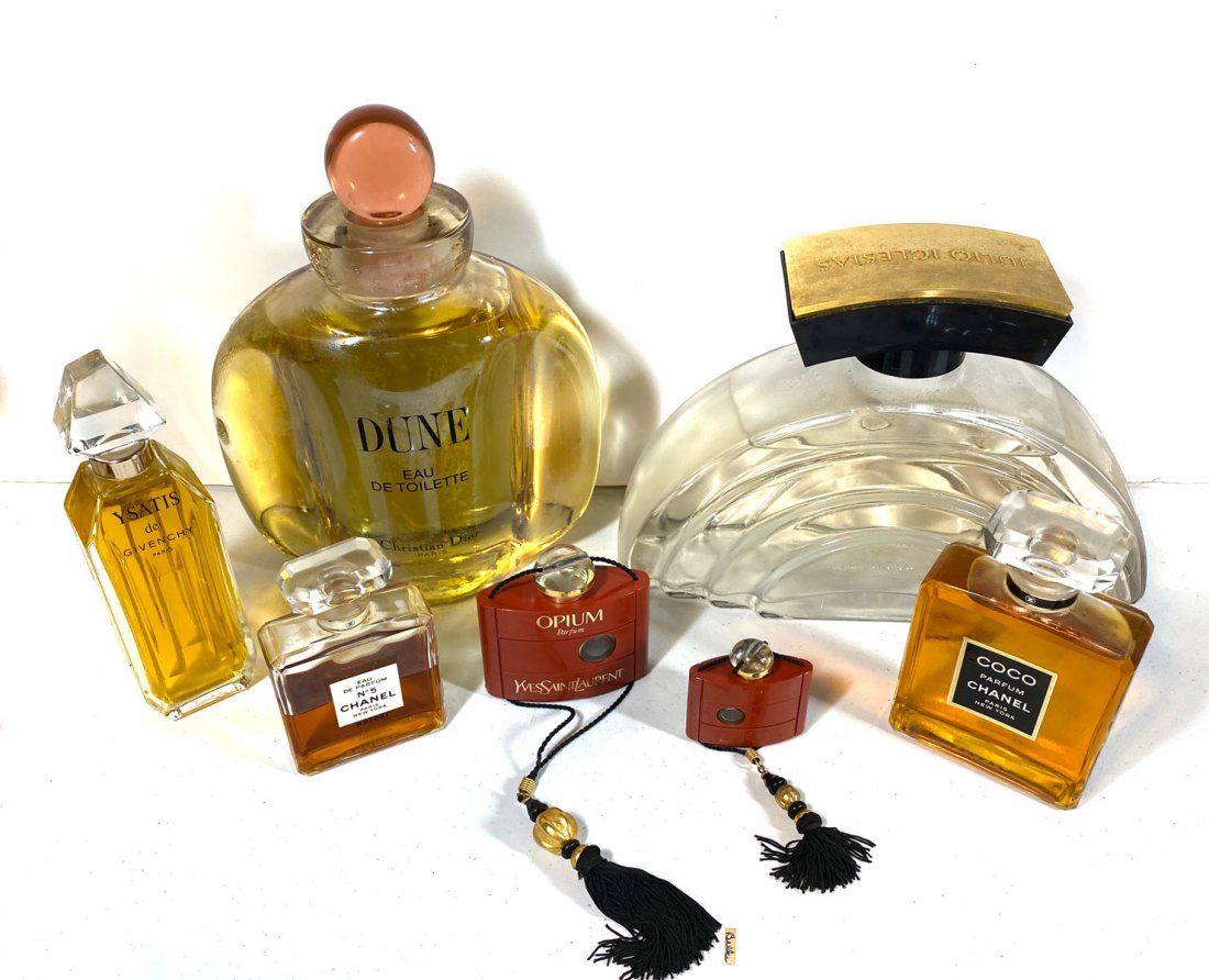 7 PIECE PERFUME BOTTLES: 7 PIECE PERFUME BOTTLES: 1) Clear & frosted glass Julio Iglesias Only factice bottle, circa 1989, 7.625" h x 11.125" w; 2) 2 Yves Saint Laurent Opium Parfum, bottles only; 3) Coco Chanel Parfum; 4) Ys