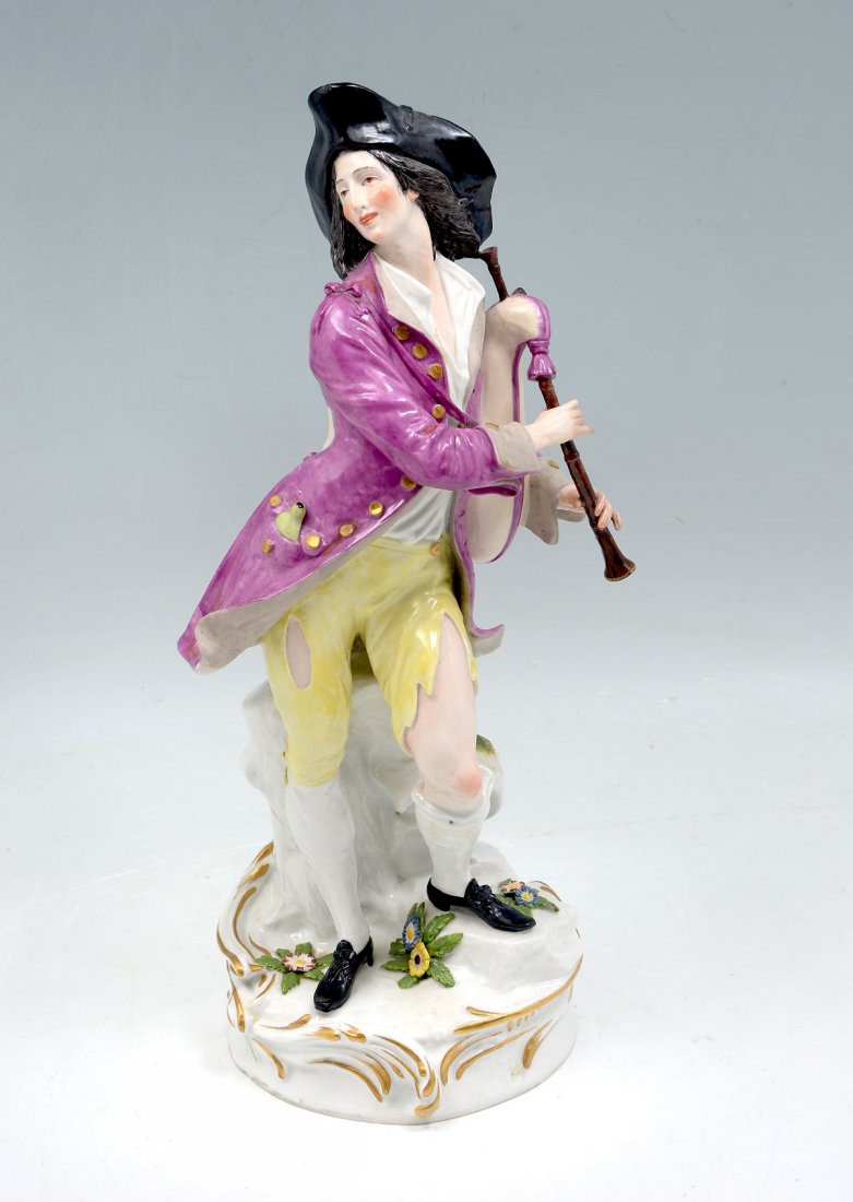 MEISSEN PORCELAIN CABINET FIGURE: MEISSEN PORCELAIN CABINET FIGURE: In 18th C. costume and bag pipes, polychrome paint, blue crossed swords under glaze at verso of base. Approx. 14.25" h x 6.25" l x 5.25" w.