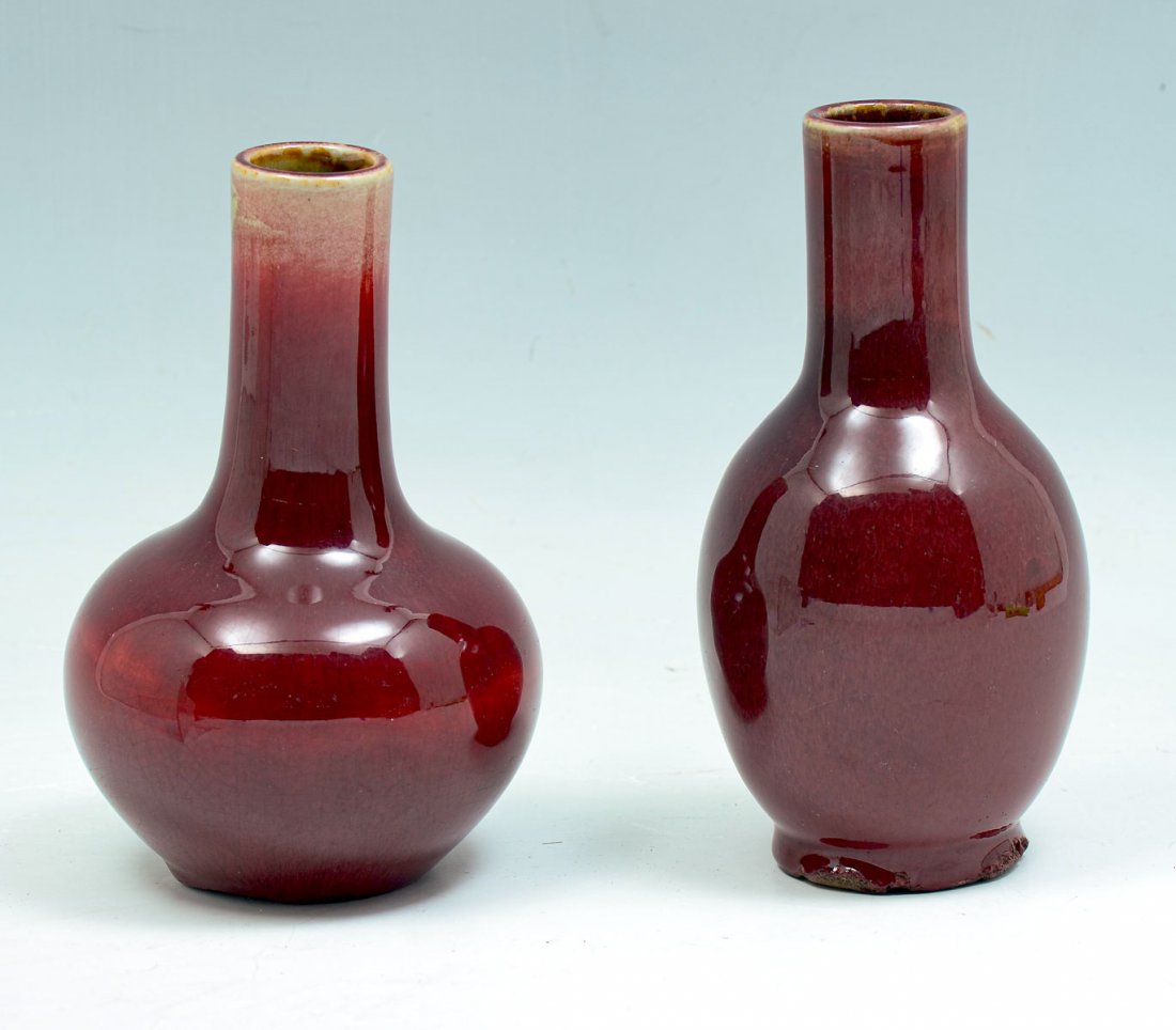 2 CHINESE FLAMBE PORCELAIN BOTTLE VASES: 2 CHINESE FLAMBE PORCELAIN BOTTLE VASES: 2- Sang de Boeuf glazed bottle vases. Largest approx. 7.25" h x 3.75" w.