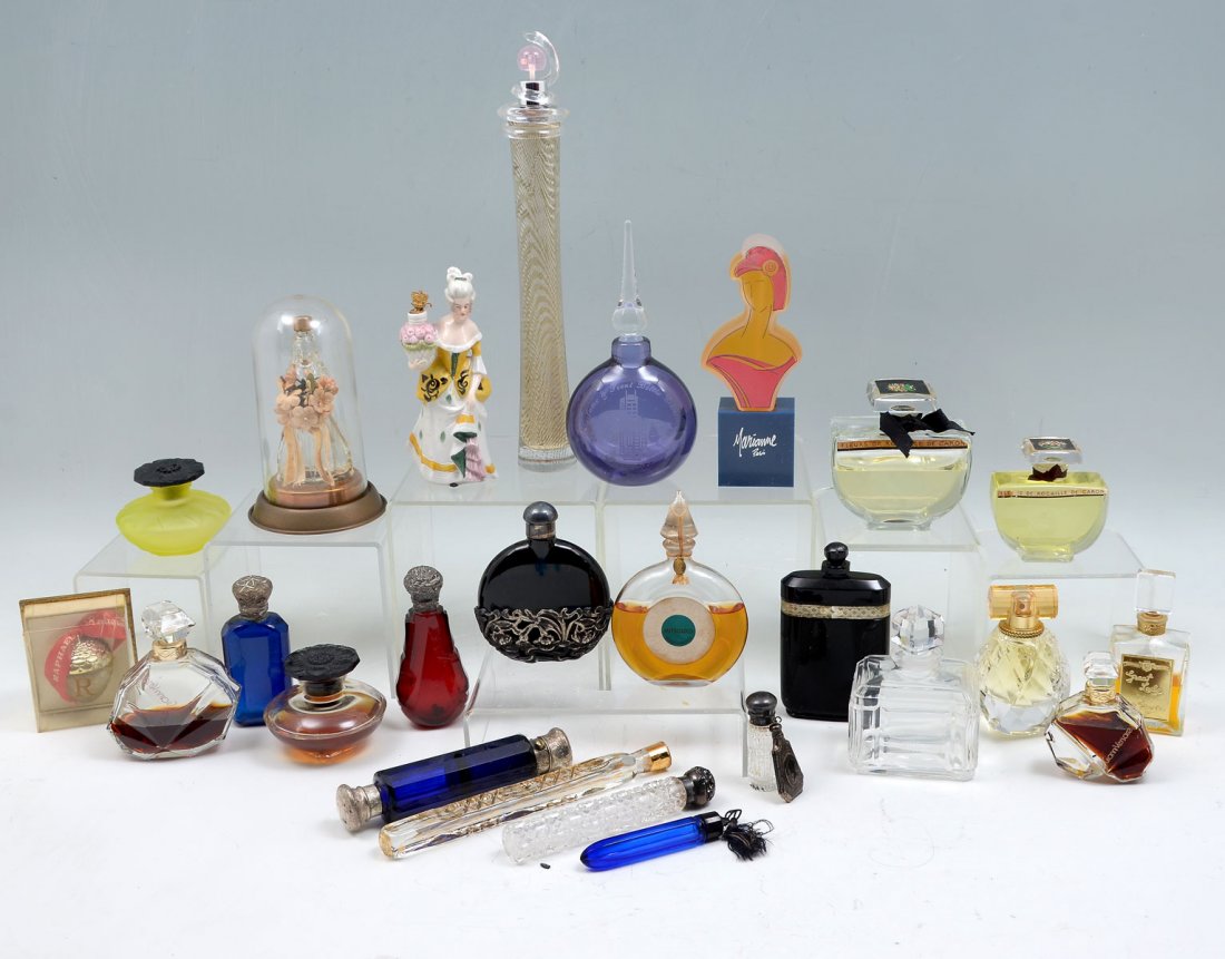 A MOST INTERESTING LOT OF PERFUME & SCENT BOTTLES: A MOST INTERESTING LOT OF PERFUME & SCENT BOTTLES Fragrances include: With Love, Gianni Versace, Great Lady, and Fleurs de Rocaille de Caron. Cut glass and sterling repousse scent bottle marked STERLI