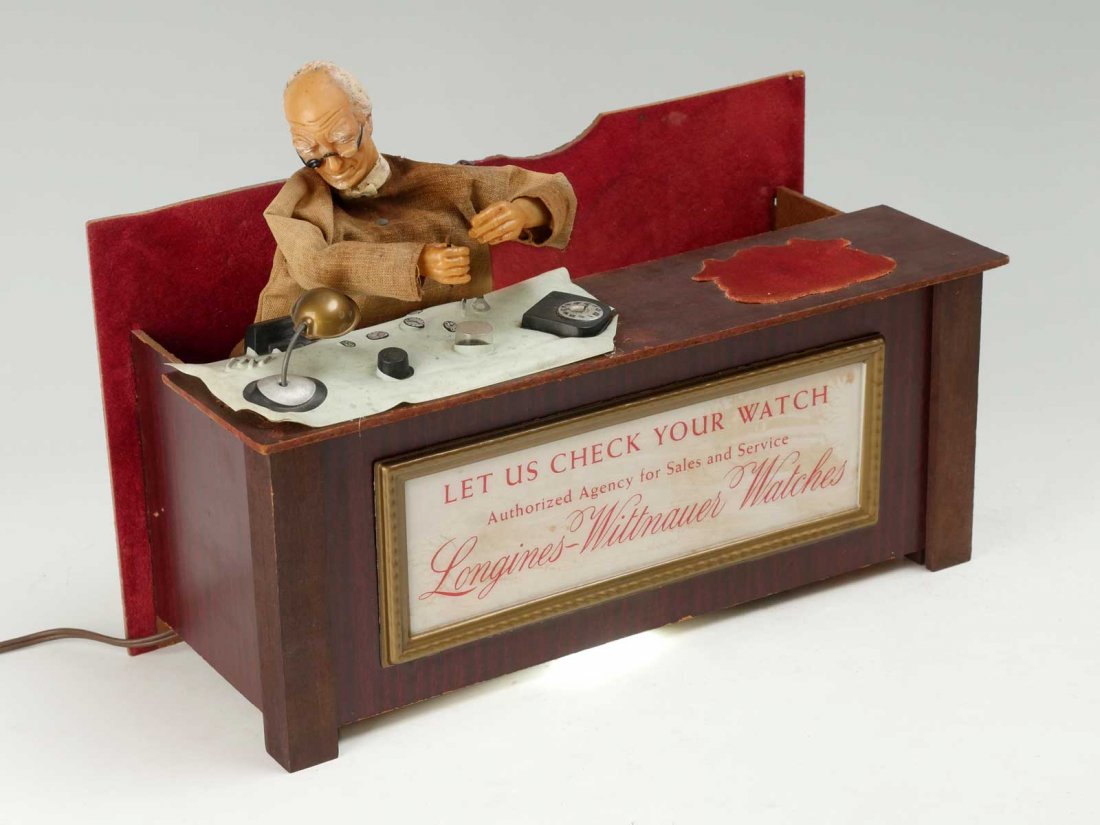 MID-20TH C. LONGINES WITTNAUER MECHANICAL WATCH DISPLAY: MID-20TH C. LONGINES WITTNAUER MECHANICAL WATCH DISPLAY: Rare 1940's-50's animated watch store display with mechanical moves the watch maker as if he is repairing or making a watch at the workbench. A