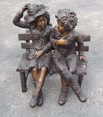 BRONZE SCULPTURE OF BOY & GIRL SITTING ON A BENCH: LARGE CONTEMPORARY BRONZE SCULPTURE OF A BOY & GIRL SITTING ON A BENCH: Approx. 32"h. x 26"w. and 20" deep. Very VERY heavy!