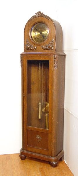 YSGUS CARVED WALNUT GRANDFATHER CLOCK: YSGUS CARVED WALNUT GRANDFATHER CLOCK: Applied carved decoration on walnut case, bubble glass top bezel, beveled glass front on body. Weight driven mechanism. Metal face with Arabic numerals and geome