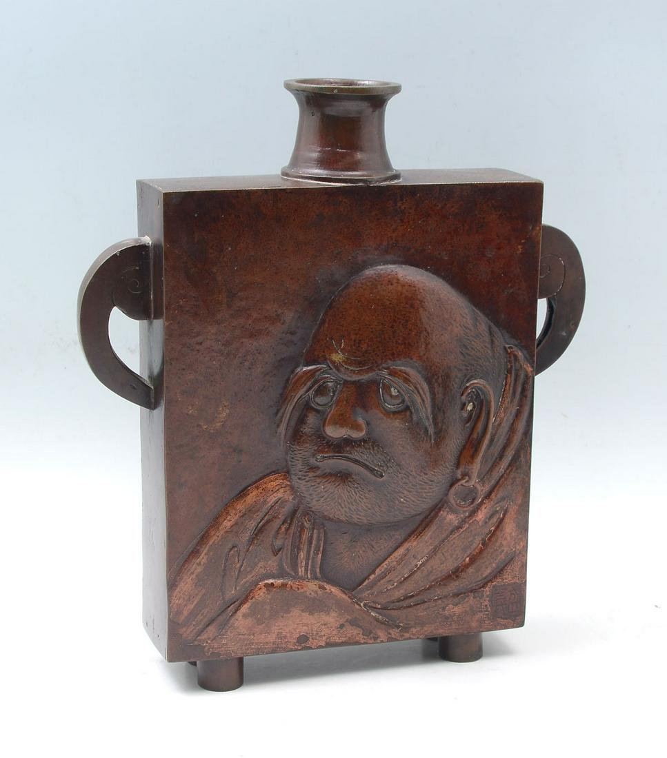 LARGE JAPANESE BRONZE FLASK: LARGE JAPANESE BRONZE FIGURAL FLASK: Large Japanese square flask, having a raised Elder/wiseman at the observe & verso. Both have an impressed makers mark at lower right. Scrolling handles, raised on