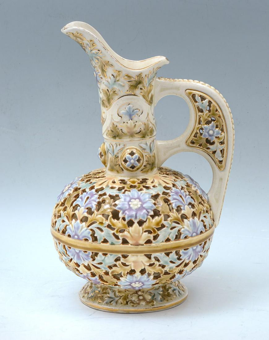 RETICULATED ZSOLNAY PITCHER: RETICULATED ZSOLNAY PITCHER: Tall Zsolnay reticulated pitcher, having an overall foliate & floral design. Impressed, ''Made in Austria-Hungaria, Zsolnay, Pecs, #2200. Red Cathedral stamp at underside.