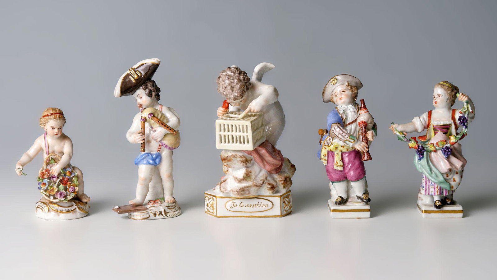 5 PC. 19TH C. MEISSEN PORCELAIN FIGURES: 5 PC. 19TH C. MEISSEN PORCELAIN FIGURES: Comprising; 2- Musicians, 1- Female holding a grapevine, 1- With floral basket, & 1- ''Le Captive''. Largest Approx. 4.25'' h x 2.5'' l x 3.5'' w.