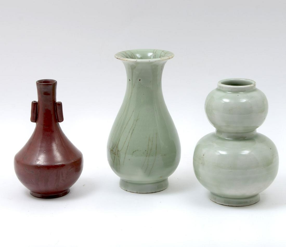 3 PC. CHINESE VASE COLLECTION: 3 PC. CHINESE VASE COLLECTION: Comprising; 1- Celadon green glazed double gourd vase, 1- Celadon green lobed vase, & 1- Red glazed earthenware bottle vase. Largest Approx. 7.75'' h x 4.25'' w.