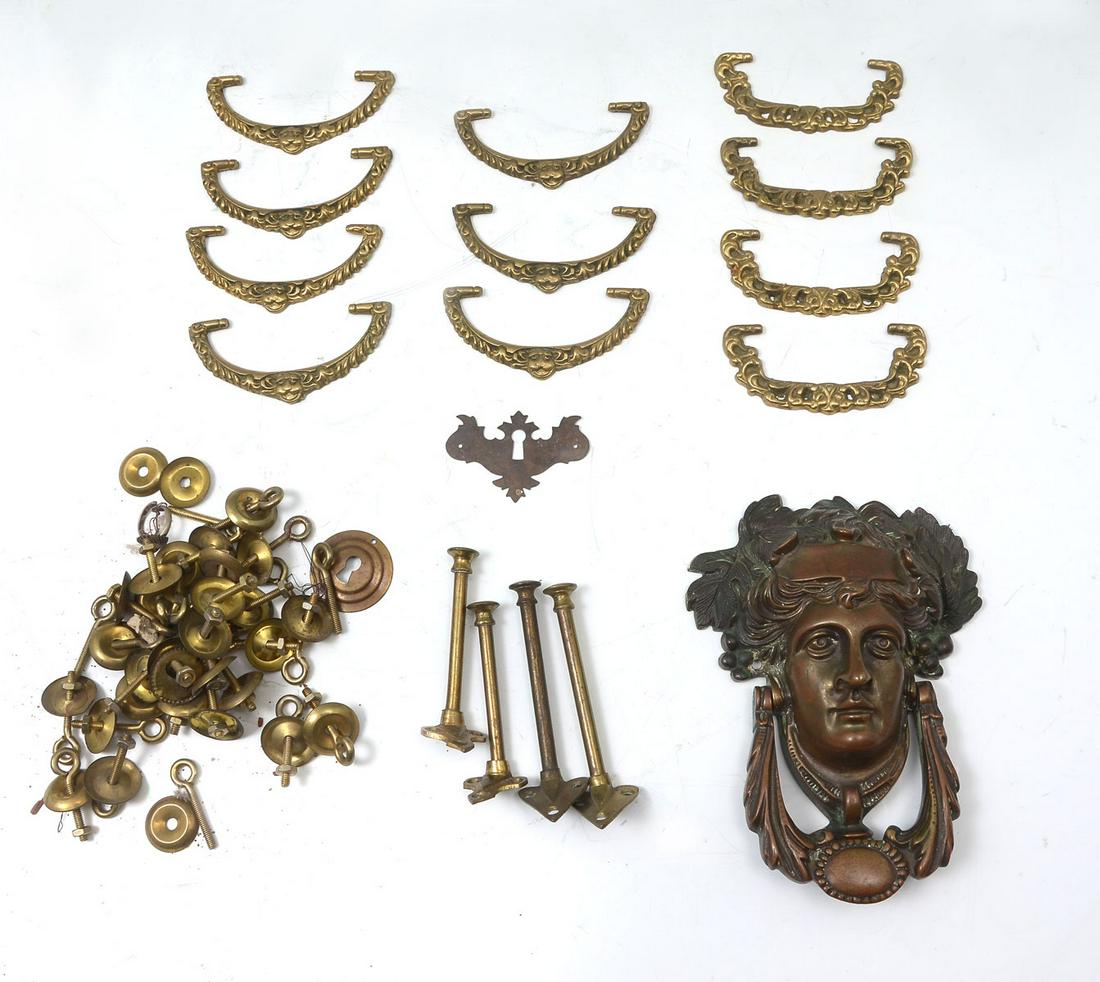 BRASS & BRONZE HARDWARE COLLECTION: BRASS & BRONZE HARDWARE COLLECTION: Comprising; 1- 19th century bronze female door knocker having grapevine wreath in hair, with a foliate knocker. 10- bail handles with mounts, and more. Largest appr