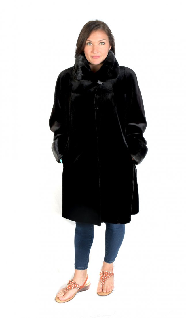 LONG BLACK SHEARED BEAVER COAT WITH MINK TRIM: FULL LENGTH BLACK SHEARED BEAVER COAT WITH BLACK MINK TRIM: Classic straigth cut black sheared beaver coat with black mink trim at the collar and cuffs with a luxurious monogramed black satin lining.