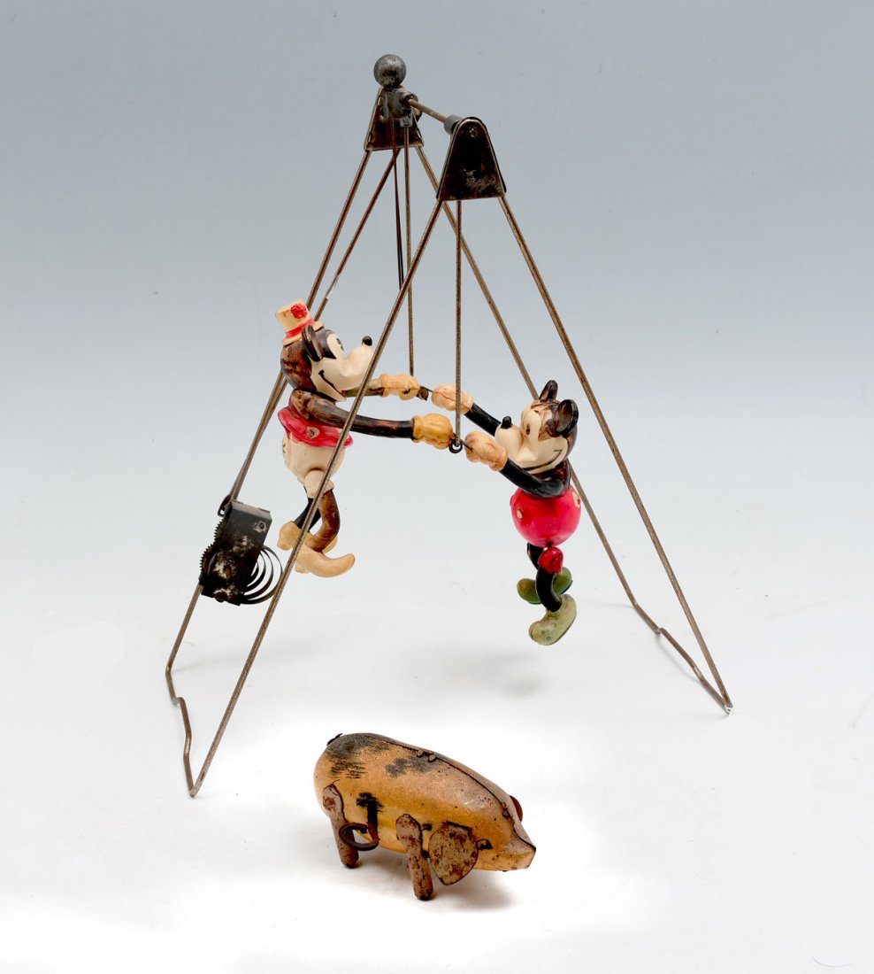DISNEYS MICKEY MOUSE SWING AND WIND UP PIG: DISNEY'S MICKEY MOUSE SWING AND WIND-UP PIG: Celluloid trapeze windup toy, circa 1930. Frame condenses. Sold with an early wind-up toy pig. Largest Approx. 12" h x 6" 11" l x 6" w.