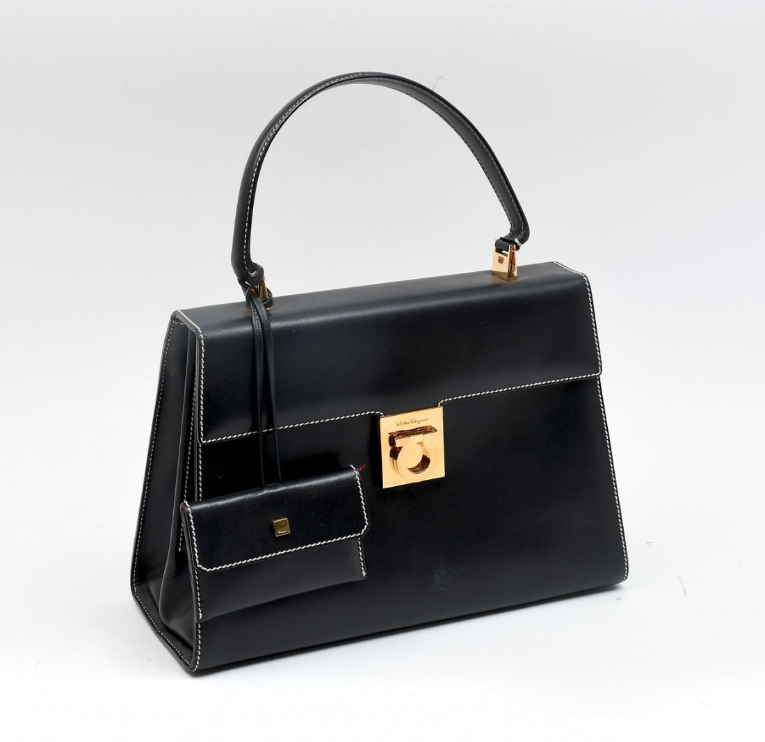 VINTAGE SALVATORE FERRAGAMO BLACK PURSE: VINTAGE SALVATORE FERRAGAMO BLACK PURSE: Classic Ferragamo black hand purse with contrasting whit stitching and gold like hardware. Signature red lining with 1 zipper pocket and one open pocket.