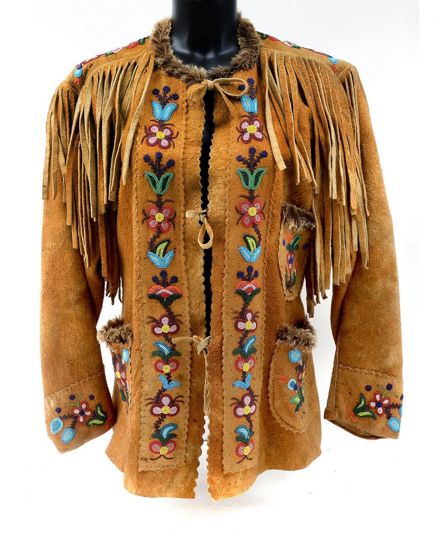 NORTHEAST WOODLANDS INDIAN BEADED JACKET WITH FRINGE: NORTHEAST WOODLANDS INDIAN BEADED JACKET WITH FRINGE: Reservation era ladies' jacket with beaded floral motif along front, pockets, cuffs and top of back. Fur trim on collar and pockets. 30'' h. x 19 