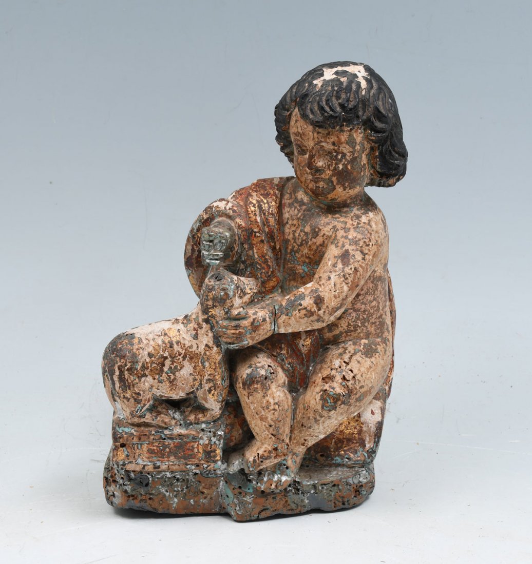 EARLY CARVED AND PAINTED CHILD WITH LAMB: EARLY CARVED AND PAINTED CHILD WITH LAMB: Carved figure with lamb. Polychrome & gilt. Approx. 9.75" h x 6.5" l x 3.25" w.