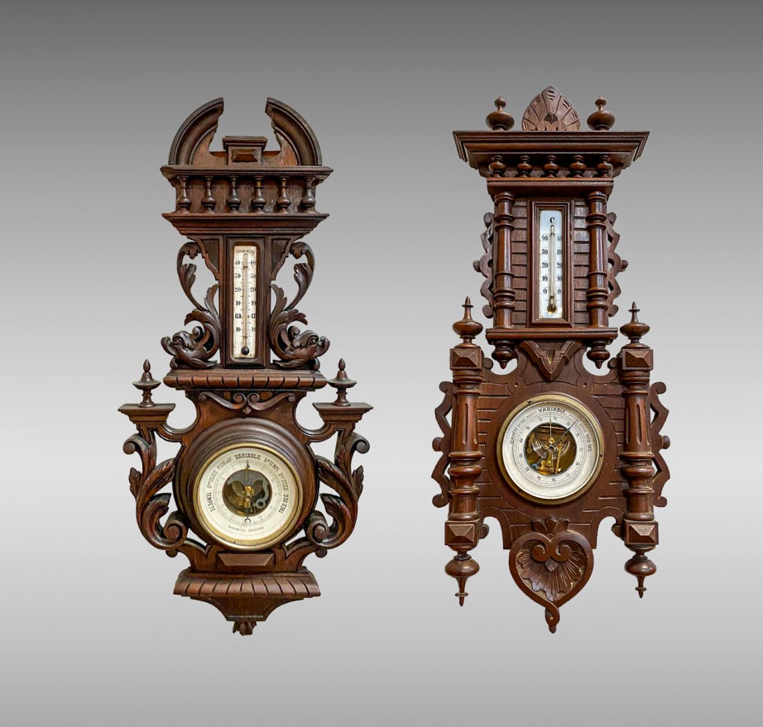LOT OF 2 VICTORIAN CARVED WALNUT BAROMETERS: LOT OF 2 VICTORIAN CARVED WALNUT BAROMETERS: 1 Carved Aneroid Barometer whose thermometer is flanked by stylized dolphin carvings; 2 Carved victorian Barometer with split turned fluted columns abd sti