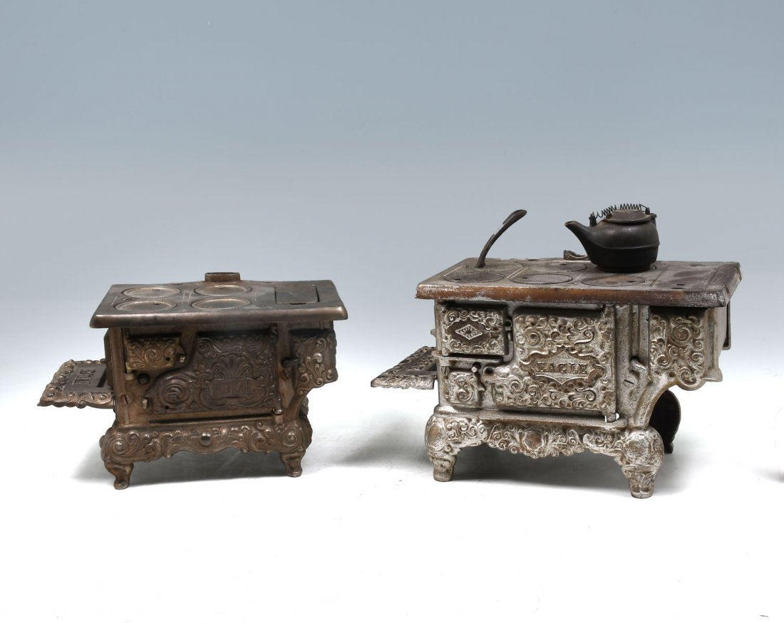 TWO CAST IRON MINIATURE STOVES: TWO CAST IRON MINIATURE STOVES: 1- Silver painted Eagle, a Lancaster brand, stove. 1- Kenton brand, Royal stove with an extrea stove top, hot water pot, skillet, and 2- handles for fifting stove tops.