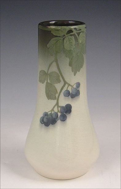 ROOKWOOD IRIS VASE C. LINDEMAN: ROOKWOOD POTTERY IRIS GLAZE VASE EXECUTED BY CLARA LINDEMAN: Iris glaze with blue berries and leaves. Marked with the Rookwood logo, date mark for 1908, shape 1278E, artists initials CCL, and the W fo