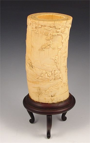 CHINESE CARVED IVORY TUSK: CHINESE CARVED IVORY TUSK: Carved with scene of 2 men pulling boat along stream. Tusk measures 7 1/4" high, affixed to footed wooden base, 10 3/4" high overall x 4 3/4" oval dia.