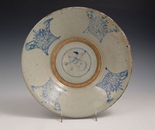 SOUTHEAST ASIAN BLUE DECORATED EARTHENWARE BOWL: SOUTHEAST ASIAN BLUE DECORATED EARTHENWARE BOWL: All over crazing with decoration to the interior. It is has been said that bowl is end of Ming, Ca 1644 but is not guaranteed. 10 1/2" dia. 2 1/4" h.