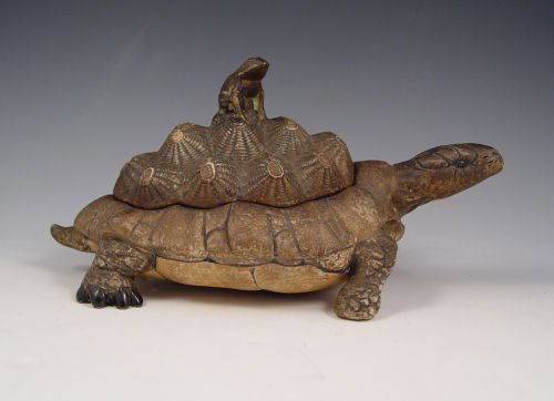 TURN TEPLITZ AMPHORA MODEL OF A TORTOISE: TURN TEPLITZ AMPHORA MODEL OF A TORTOISE: Ca. 1918-1939. Covered jar in the form of a tortoise with a frog as his passenger. 5 1/4'' high x 10'' wide