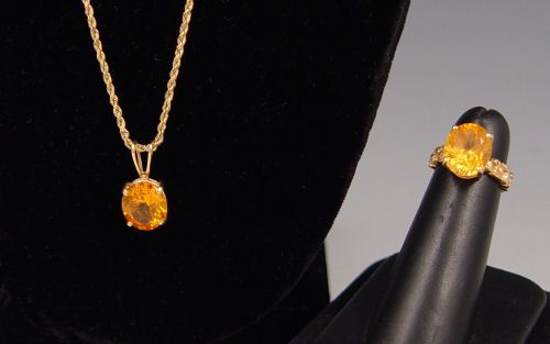 CITRINE RING & NECKLACE: CITRINE RING & NECKLACE: 14K yellow gold ring and 14K yellow gold pendant contain 2 oval shaped mixed cut citrine. Weight: 6.00 Ct. Approx. The stones are prong set. Pendant hangs from a 14K yellow go