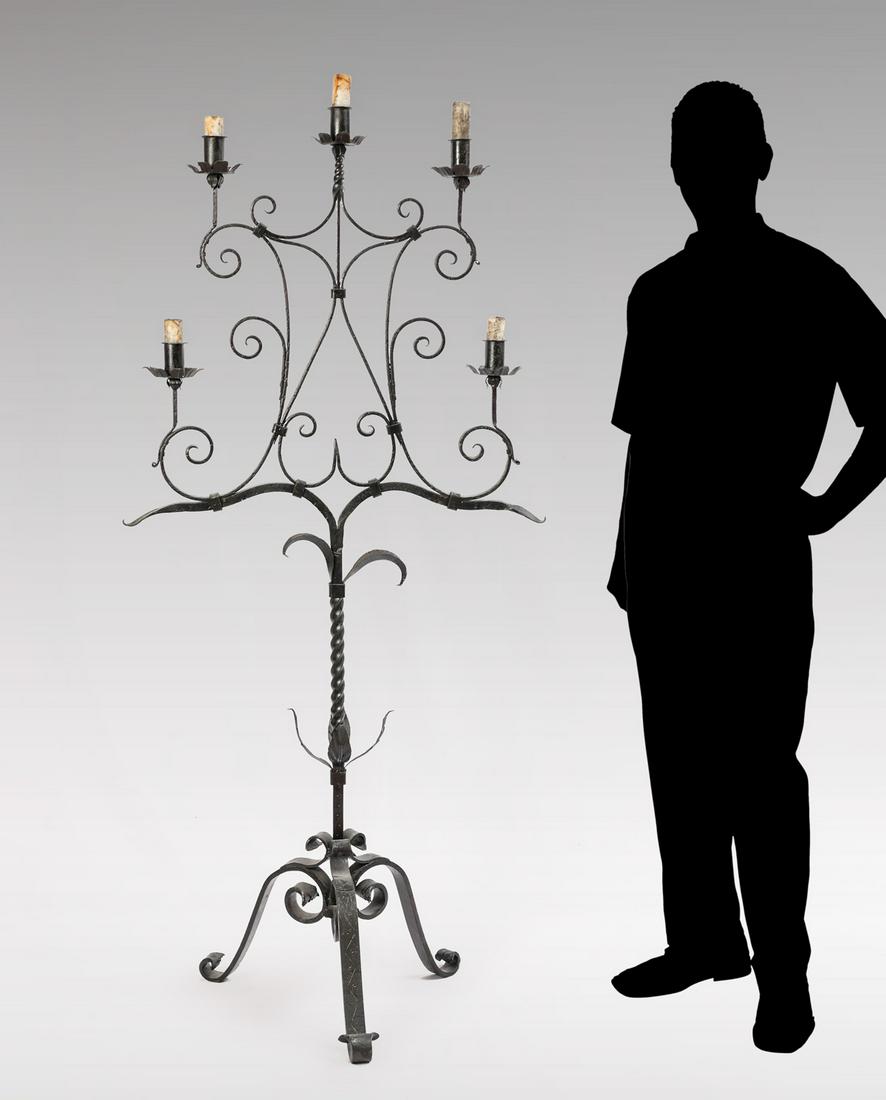 WROUGHT IRON FLOOR CANDELABRA: WROUGHT IRON FLOOR CANDELABRA: Overall scrolling design with twisted accents and attached foliate. Raised on scrolling feet. Approx. 66'' h x 31'' l x 19.25''.