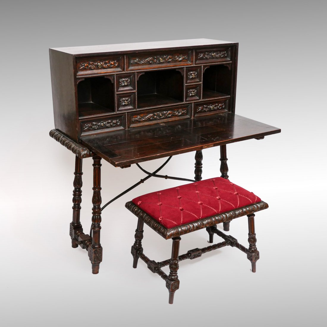 CARVED VARGUENO DESK WITH BENCH: CARVED VARGUENO DESK WITH BENCH: 10- Drawer compartmented desk with a drop front writing surface. Resting on a base with pull-out supports for writing surface. Overall carved foliate design with flora