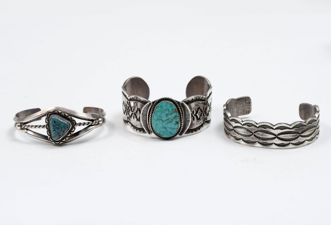 3 NATIVE AMERICAN INDIAN CUFF BRACELETS: 3 NATIVE AMERICAN INDIAN CUFF BRACELETS: 1) Signed Ben Yellowhorse stamped sterling cuff bracelet measures 5.25" with 1.25" opening and .75" w. Weighs 42.4 grams. Previously offered by the Heard Museu