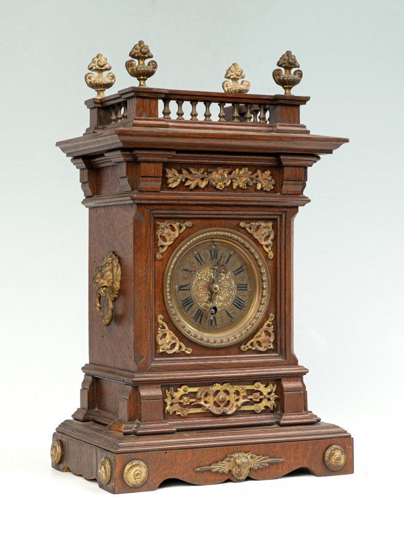 LENZKIRCH WOOD MANTLE CLOCK: LENZKIRCH WOOD MANTLE CLOCK: Ormolu mounted wood mantle clock surmounted by a gallery with metal bountiful urns. Lenkirch clockworks. Approx. 15.25" h z 10" l x 6.5" w.