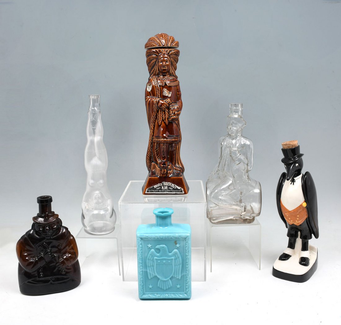 6 PC. PORCELAIN & GLASS FIGURAL LIQUOR DECANTERS: 6 PC. PORCELAIN & GLASS FIGURAL LIQUOR DECANTERS: Comprising; 1- ''Old Crow'' Penguin porcelain decanter, 1- Glass American Eagle decanter, 1- Glass Pilgrim form decanter, 1- Glass Man on Barrel decan