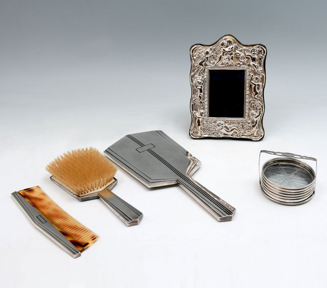INTERNATIONAL STERLING ART DECO DRESSER SET & FRAME: INTERNATIONAL STERLING ART DECO DRESSER SET & FRAME: Comprising; 3- Pc. art deco vanity set, monogrammed "TLH". 1- English Sterling repousse Cherub picture frame, & 6- Sterling & glass coasters in a c