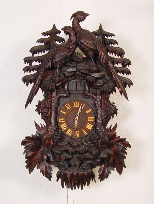 IMPRESSIVE BLACK FOREST CARVED CUCKOO CLOCK: IMPRESSIVE BLACK FOREST CARVED CUCKOO CLOCK: Early 20th century, carvings include double birds, trees, mushrooms and other designs. Marked on Cuckoo Clock Mfg Co. on mechanism. Has 2 pinecone weights.