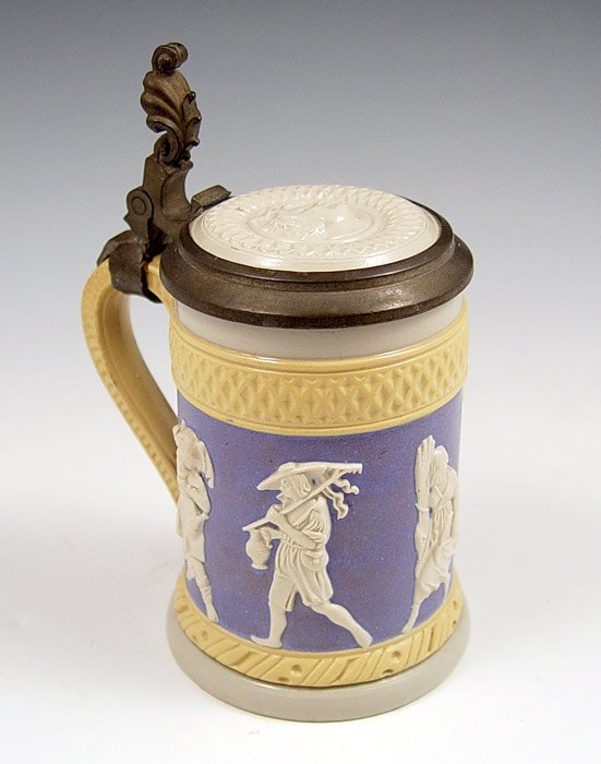 METTLACH RELIEF STEIN #171: METTLACH RELIEF STEIN #171: 1/2 liter, relief figural designs. Measures 6 1/4'' high to top of thumb press, 4 1/2'' at handle.
