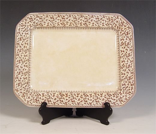 D B & Co BROWN TRANSFERWARE PLATTER: STAFFORDSHIRE BROWN TRANSFERWARE PLATTER: Dunn Bennett & Co, Ca. 1875-1907. Octagonal platter in the Eureka pattern. 18" x 14 1/2". Some discoloration, no chips.