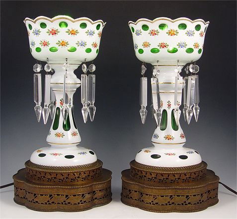 MANTLE LUSTERS: MANTLE LUSTERS: White cut to emerald green with, crystal prisms, mounted on reticulated base. These have been fitted for electricity for illumination from inside. 15"h.