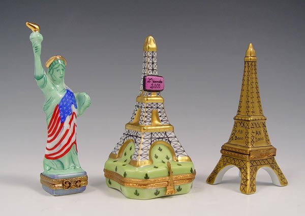 3 FRENCH LIMOGES PORCELAIN BOXES: 3 FRENCH LIMOGES PORCELAIN BOXES: 1) In the box, a limited edition Artoria Eiffel Tower with bottle of champagne, 3 1/2". 2) Signed Julia Grant Statue of Liberty, 4". 3) Limited edition Eiffel Tower w