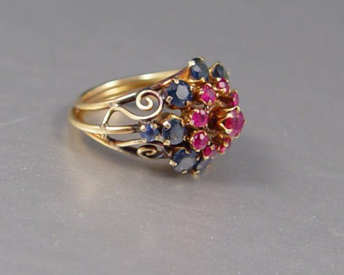 14K RUBY & SAPPHIRE COCKTAIL RING: 14K RUBY & SAPPHIRE COCKTAIL RING: 14K yellow gold ring contains 19 round faceted rubies and sapphires, total approx. 2 Ct. Size 5.5.