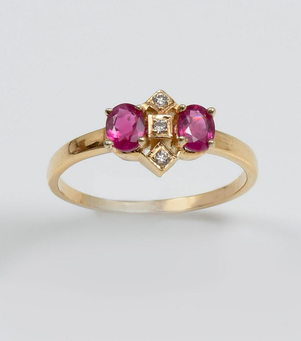 14K RUBY & DIAMOND RING: 14K RUBY & DIAMOND RING: 14K yellow gold ring contains 2 oval mixed cut rubies. WEIGHT: .65 Ct. Approx. Rated VS-SI in clarity (Type II), R in Hue, 5 in Tone and 3-4 in Saturation. 3 round brilliant c