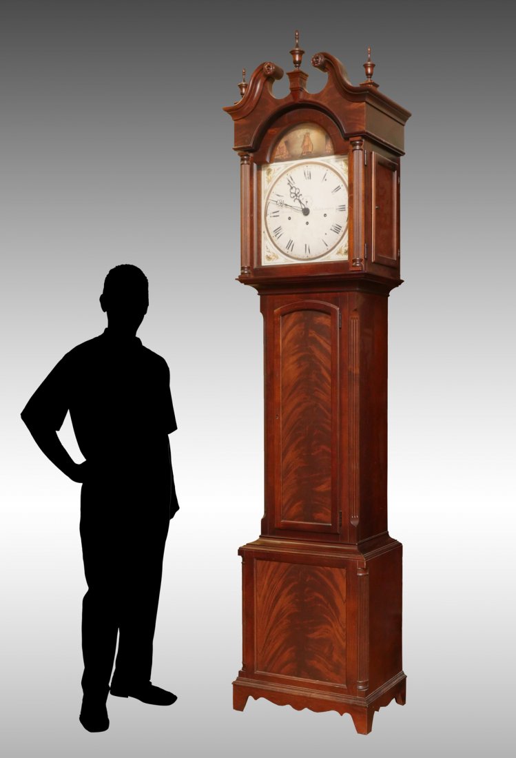 HOWARD MILLER GRANDFATHER CLOCK: HOWARD MILLER GRANDFATHER CLOCK: Having a painted wood face with a ship above. Scrolling crest with turned finials. Approx. 100" h x 24" l x 15.5" w.