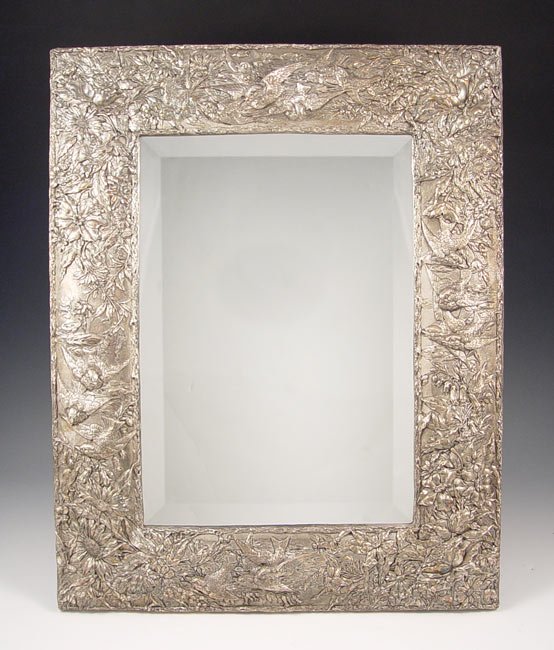 EMBOSSED STERLING REPOUSSE MIRROR: EMBOSSED STERLING REPOUSSE MIRROR: Assorted birds & flowers motif, beveled mirror, easel back. Simply stamped JR and 925 in lozenges. Measures 19 1/2'' x 15 1/2'' overall.