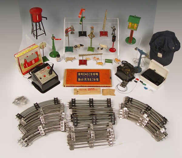 LIONEL & O GAUGE MODEL TRAIN ACCESSORIES GROUP: LIONEL & O GAUGE MODEL TRAIN ACCESSORIES GROUP: To include 1) American Flyer Lines water tower 9 1/4'' h. 2) Electrified lamp post with bulbs 7 1/2'' h. 3) Railroad crossing sign on post 6 3/4'' h. 4)