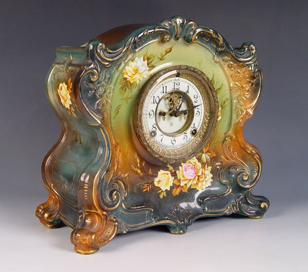 ROYAL BONN ANSONIA PORCELAIN CLOCK: ROYAL BONN LA CANTAL PORCELAIN MANTLE CLOCK: Open escapement on Ansonia marked dial, muted greens and floral decoration on porcelain Royal Bonn marked case. Marked Ansonia on the key and pendulum move