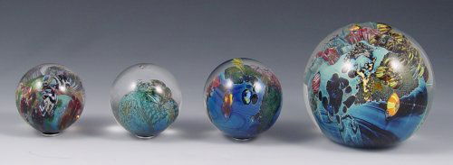 JOSH SIMPSON ART GLASS PAPERWEIGHT & MARBLES: LOT OF FOUR HAND BLOWN ART GLASS ORBS BY JOSH SIMPSON: To include one paperweight, 3''dia., dated 12-28-01; three marbles approx. 1 1/2''dia., 1 5/8''dia. and 1 3/4''dia. All pieces signed. Sold as a