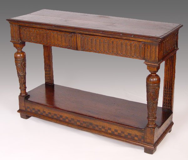 18th C SPANISH OAK SIDEBOARD SERVER: 18th C SPANISH OAK SIDEBOARD SERVER: Two drawer oak server with carved apron, 2 carved and turned front legs, flat and fluted back supports. Stretchers support a lower shelf. 31'' tall x 46 1/2'' x 17