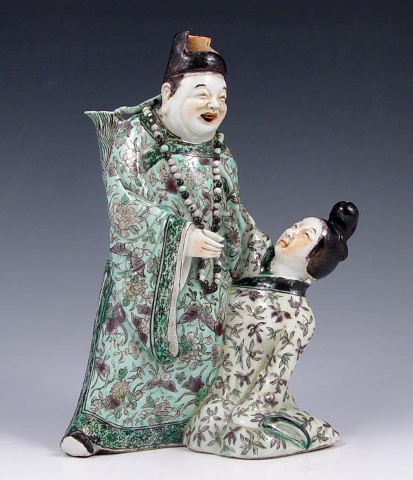 JAPANESE FIGURAL EROTICA DECANTER: JAPANESE EROTICA FIGURAL DECANTER: The man with an articulated tongue, the spout formed from the jug on his shoulder, a cup in his hand and beads around his neck. Approx. 7'' tall x 4 3/4'' dia.