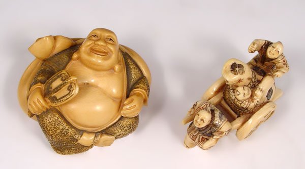 2 PIECE JAPANESE CARVED IVORY NETSUKE: 2 PIECE JAPANESE CARVED IVORY NETSUKE: To include 1) Man pulling cart with children and bag, signed in characters. 1 1/4" h. x 1 3/4" x 3/4". 2) Fat man on pillow, signed in characters, 1" h x 3" x 1 